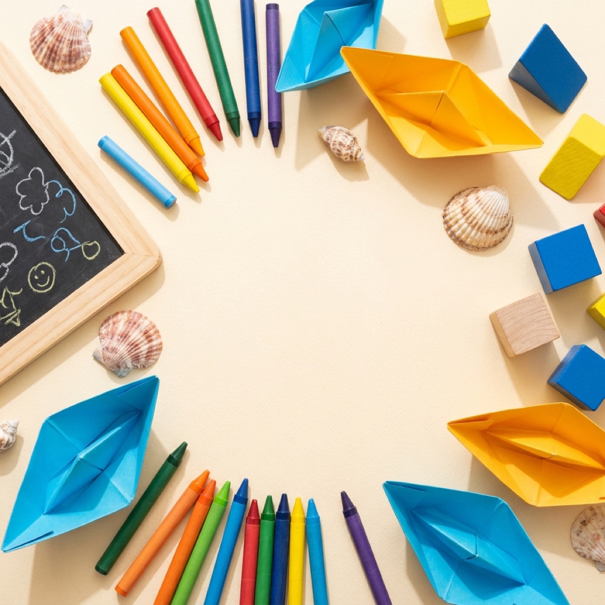 Craft table: paper boats and crayons